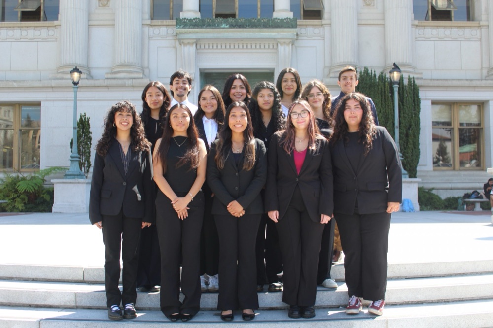 CHE members sharing a smile on the library steps