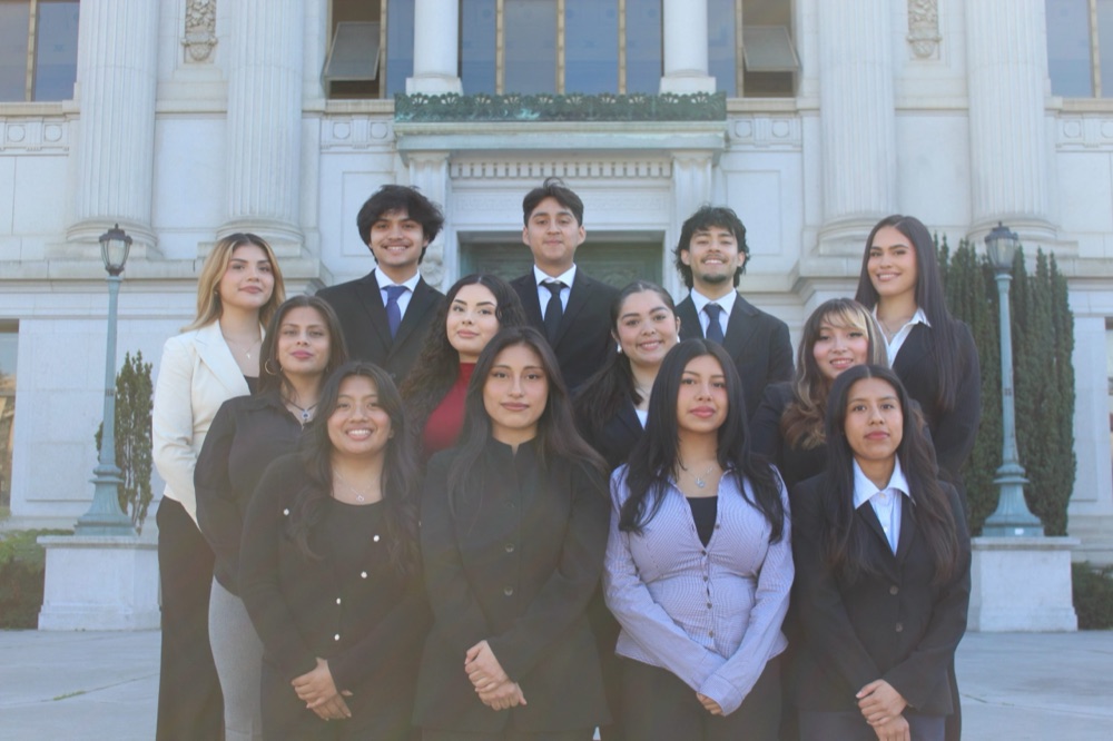 A group of CHE members dressed up for a photo outside Doe Library
