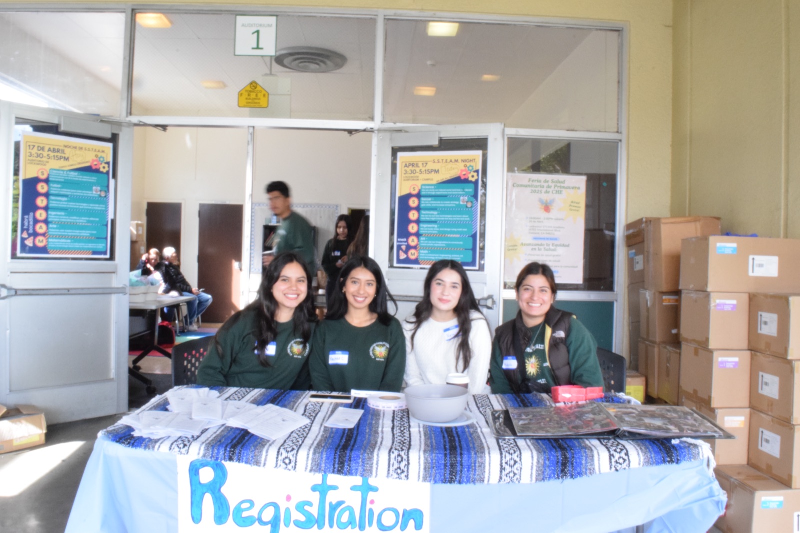 Four CHE volunteers at the registration table for the Spring 2025 Community Health Fair